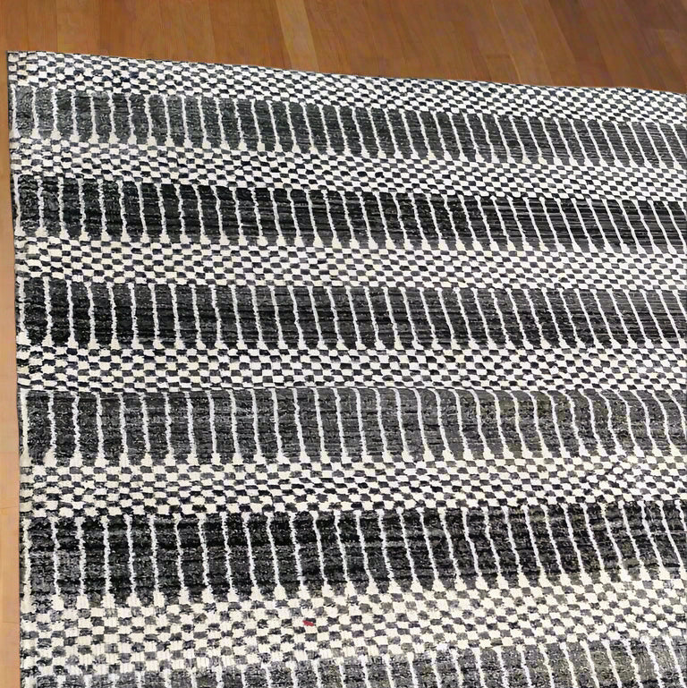 Black and white striped rug on a tiled floor